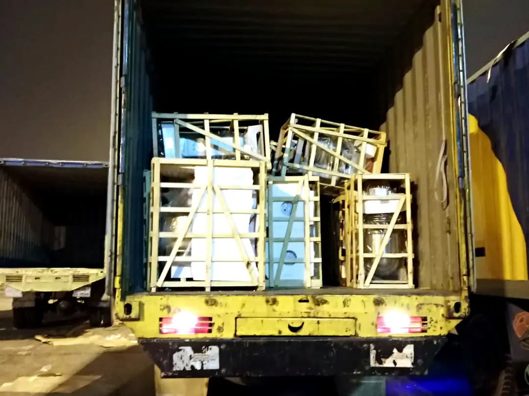 Crated machinery loaded at night