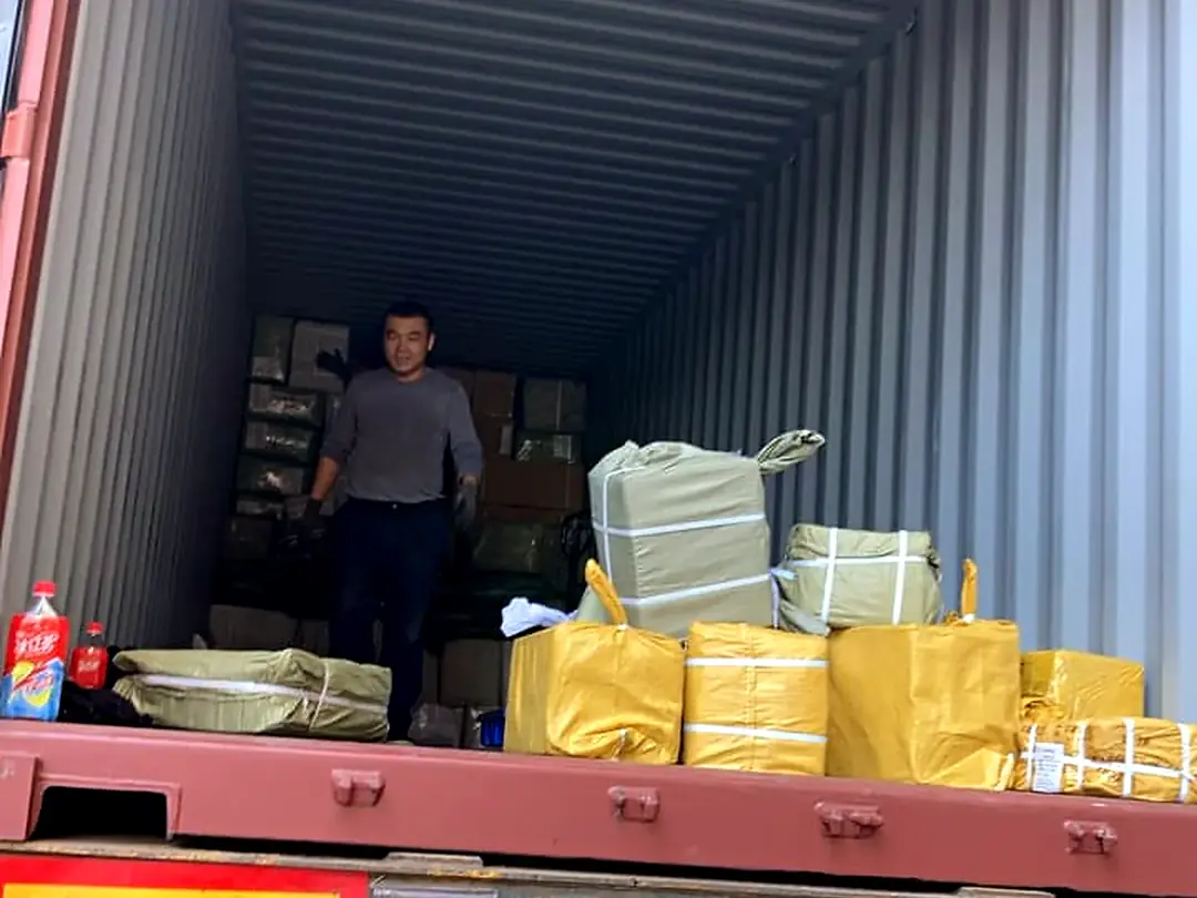Worker packing a deep container
