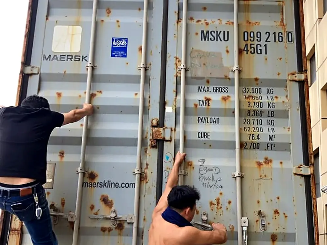 Team sealing a Maersk container
