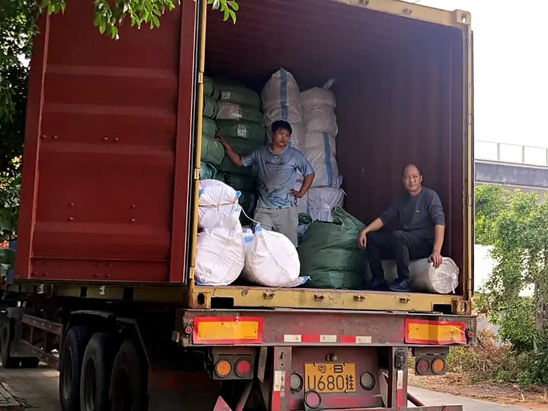 Workers loading bales onto a truck