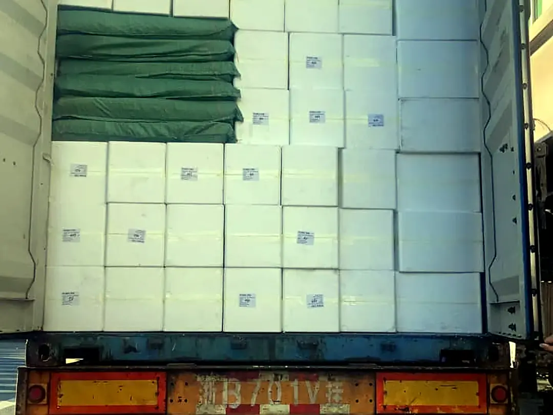 White cartons in an open container